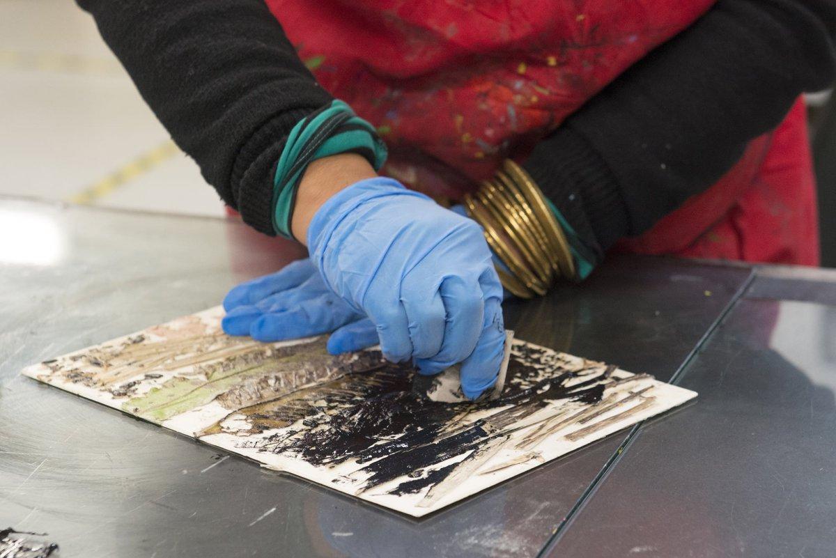 Applying ink onto a collage