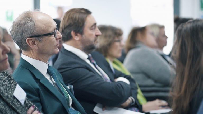 Guests at an event sit and listen to a talk