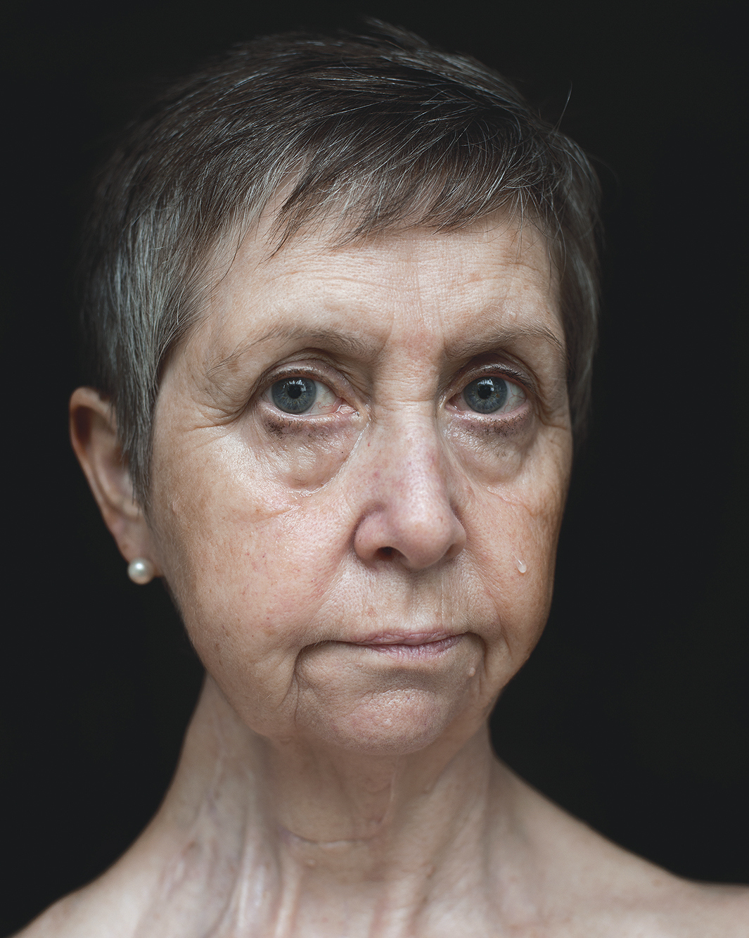 Headshot of an older woman. Part of the 'God Has No Favourites' photographic series by Lauren Forster.