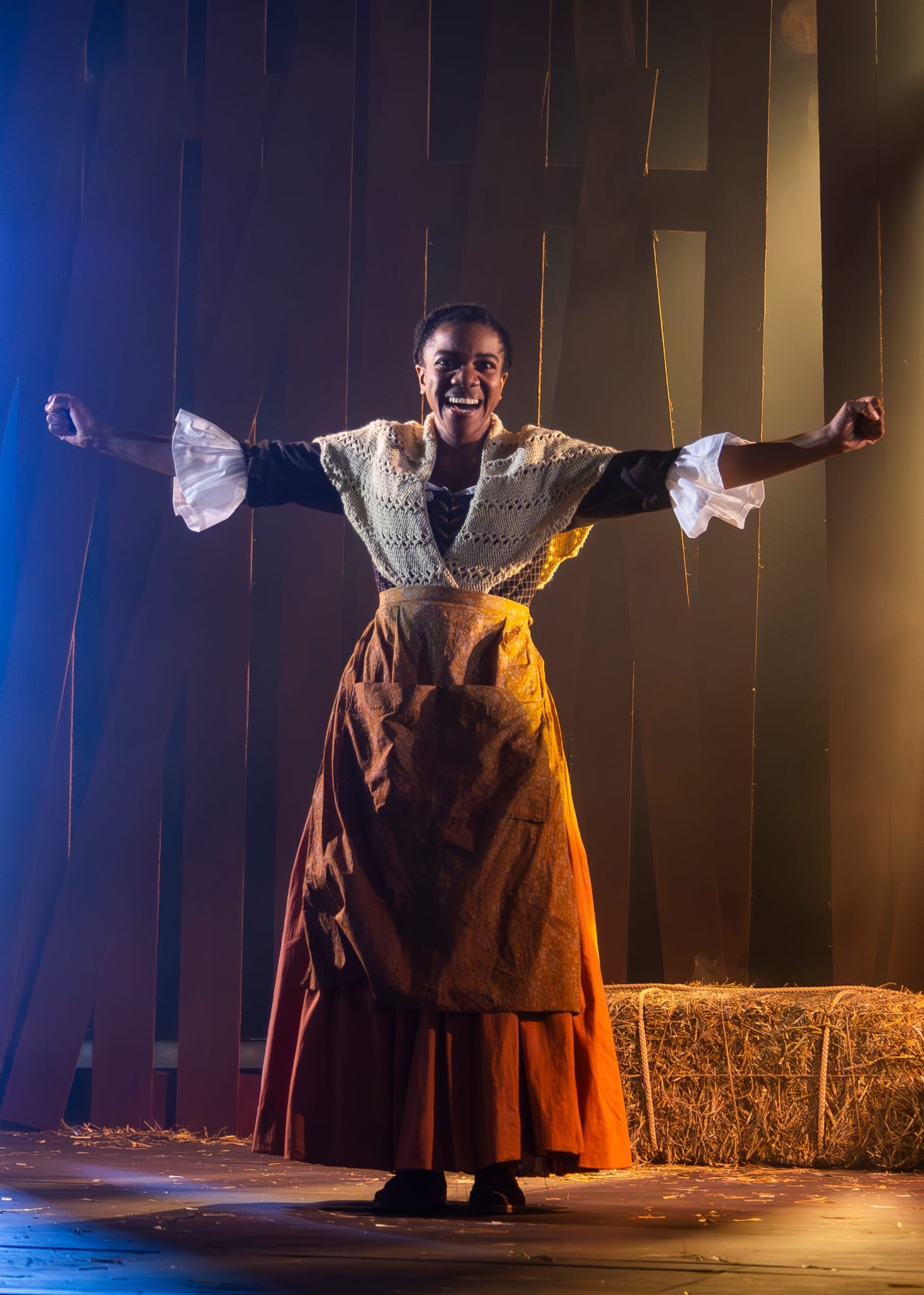 Nicole Elizabeth Phillip in The Ballad of Maria Marten, in costume, blue and orange lighting.