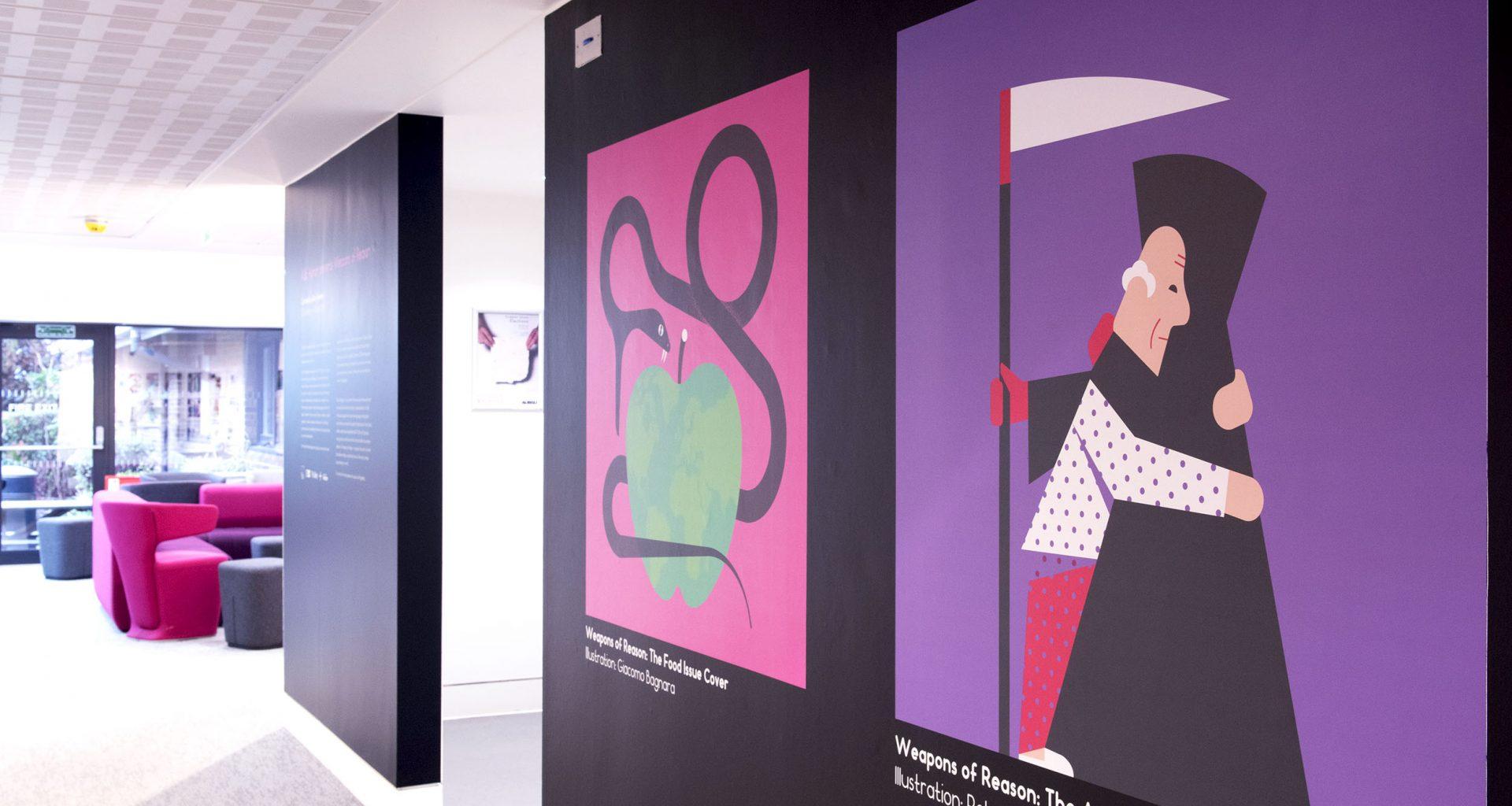 Two illustrations on a wall in a gallery space; one shows a snake about to eat a large apple, the other shows an old man hugging the Grim Reaper.