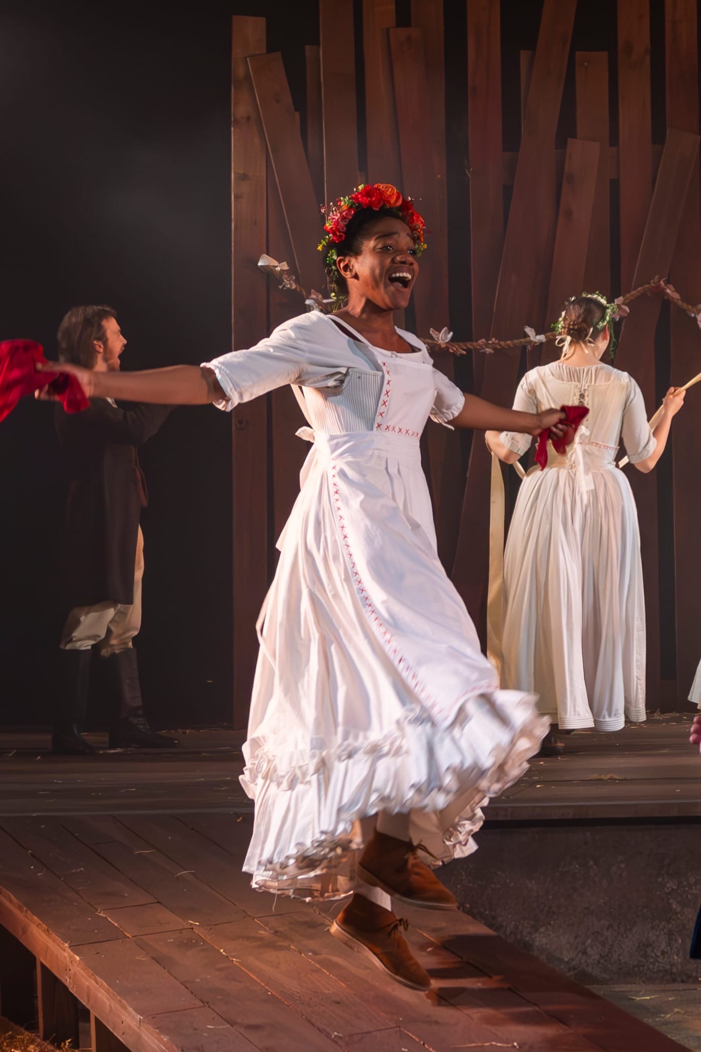 Nicole Elizabeth Phillip in The Ballad of Maria Marten, dancing with a white dress and red flowers.