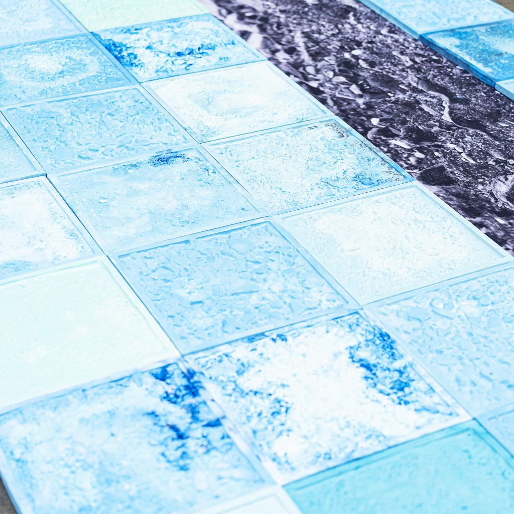 Blue glass tiles on a floor as part of an exhibition.
