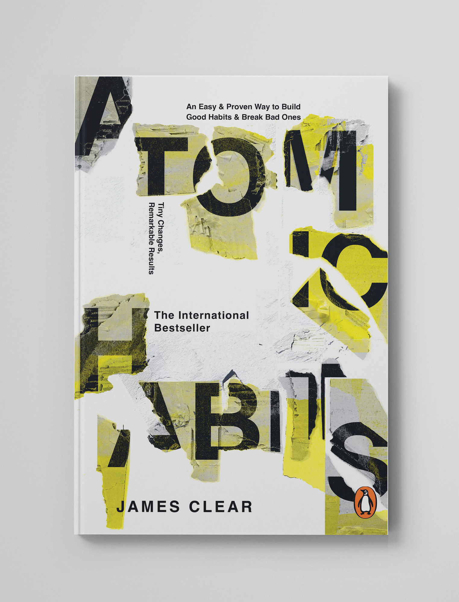 Book cover design for 'Atomic Habits' by James Clear for Penguin Books, cut-out and yellow street typography, white background.