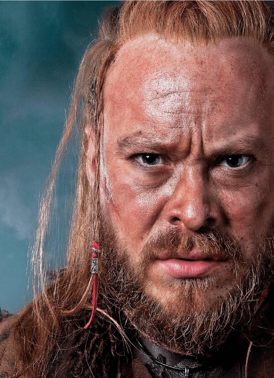 Close-up headshot of a model in Viking-style hair and makeup.