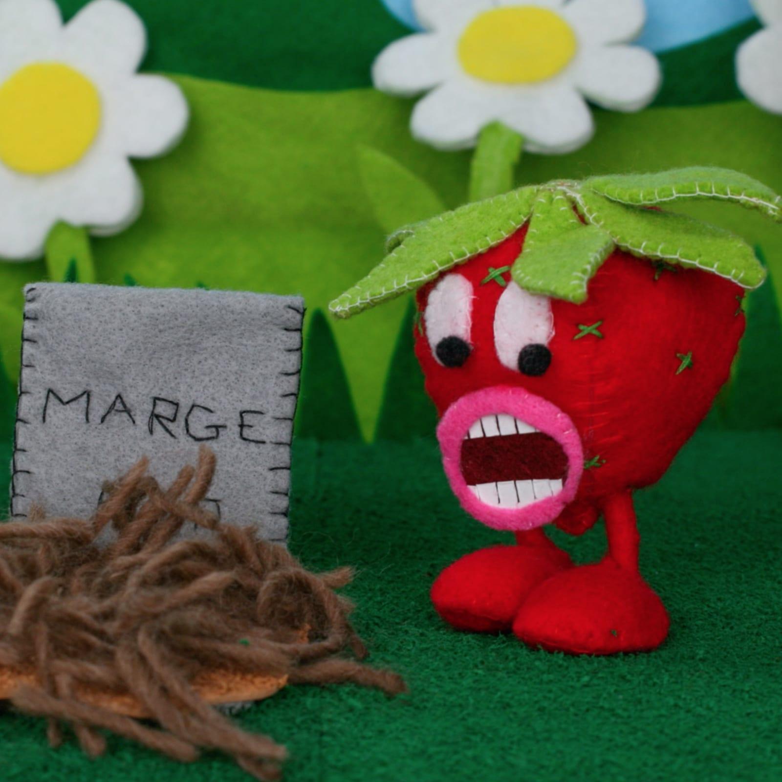 A strawberry with eyes, lips, teeth and legs, looks down with a shocked expression.