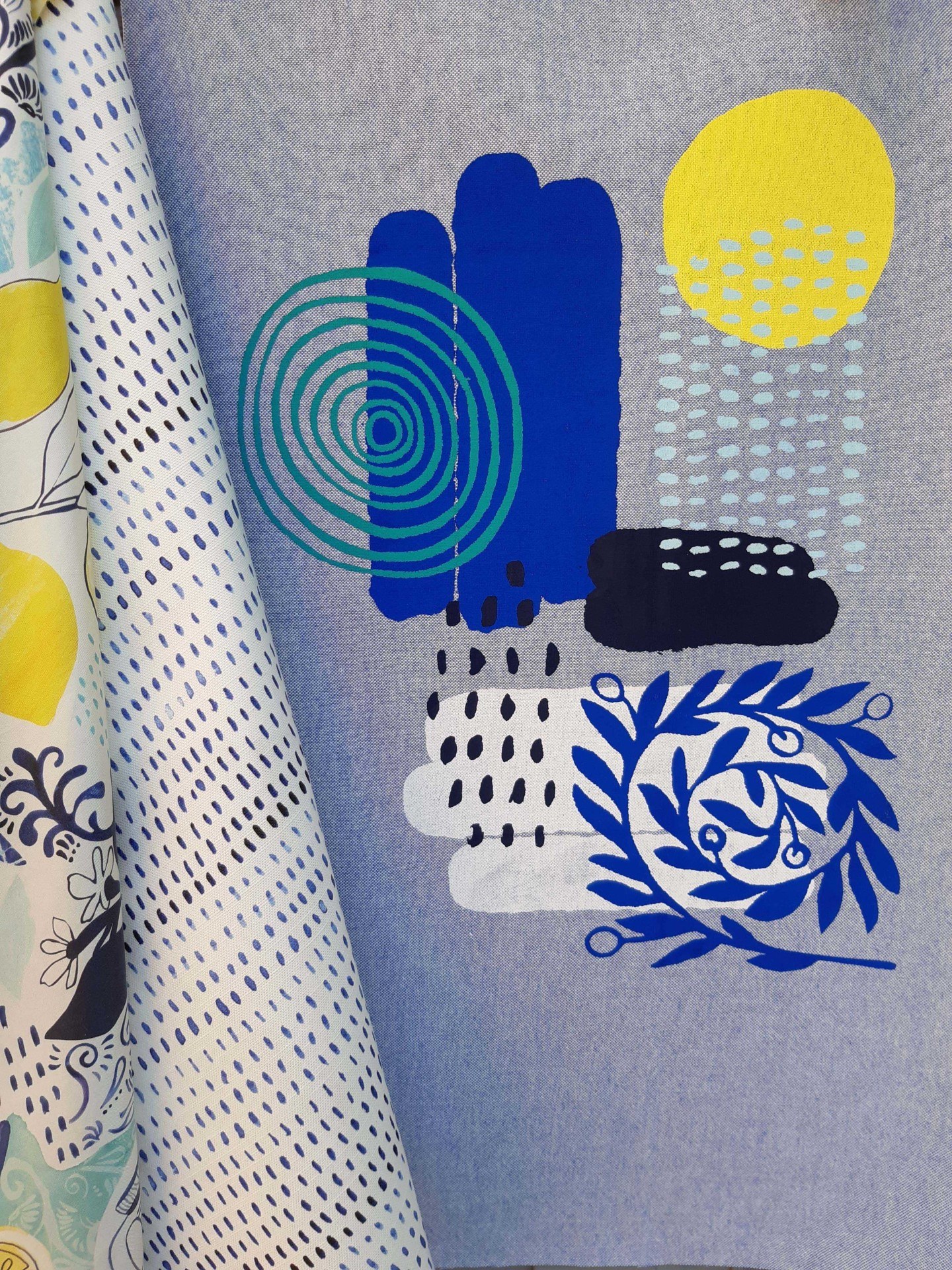 Fabric printed with a pattern inspired by weather conditions – rain, snow, cloud and sun.