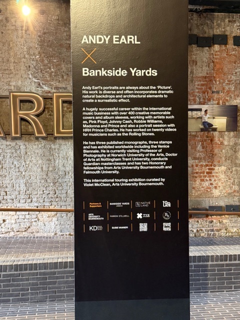 Black pillar with text that reads 'Andy Earl, Bankside Yards', brick background.