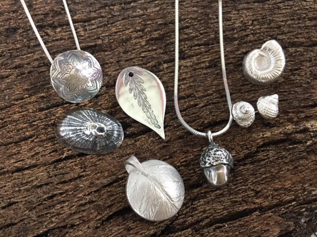 Silver pendant with several earrings