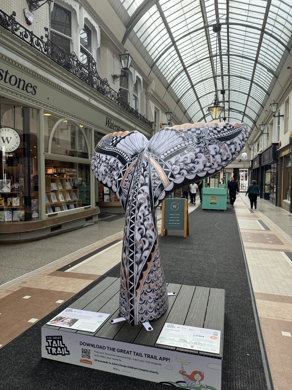 Pia Elliot's tail at Westbourne Arcade, floral art deco-style patterns in black, purple and gold.