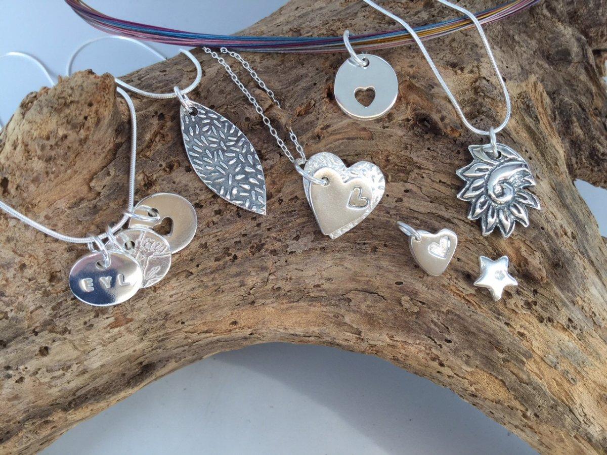Silver pendant with several earrings