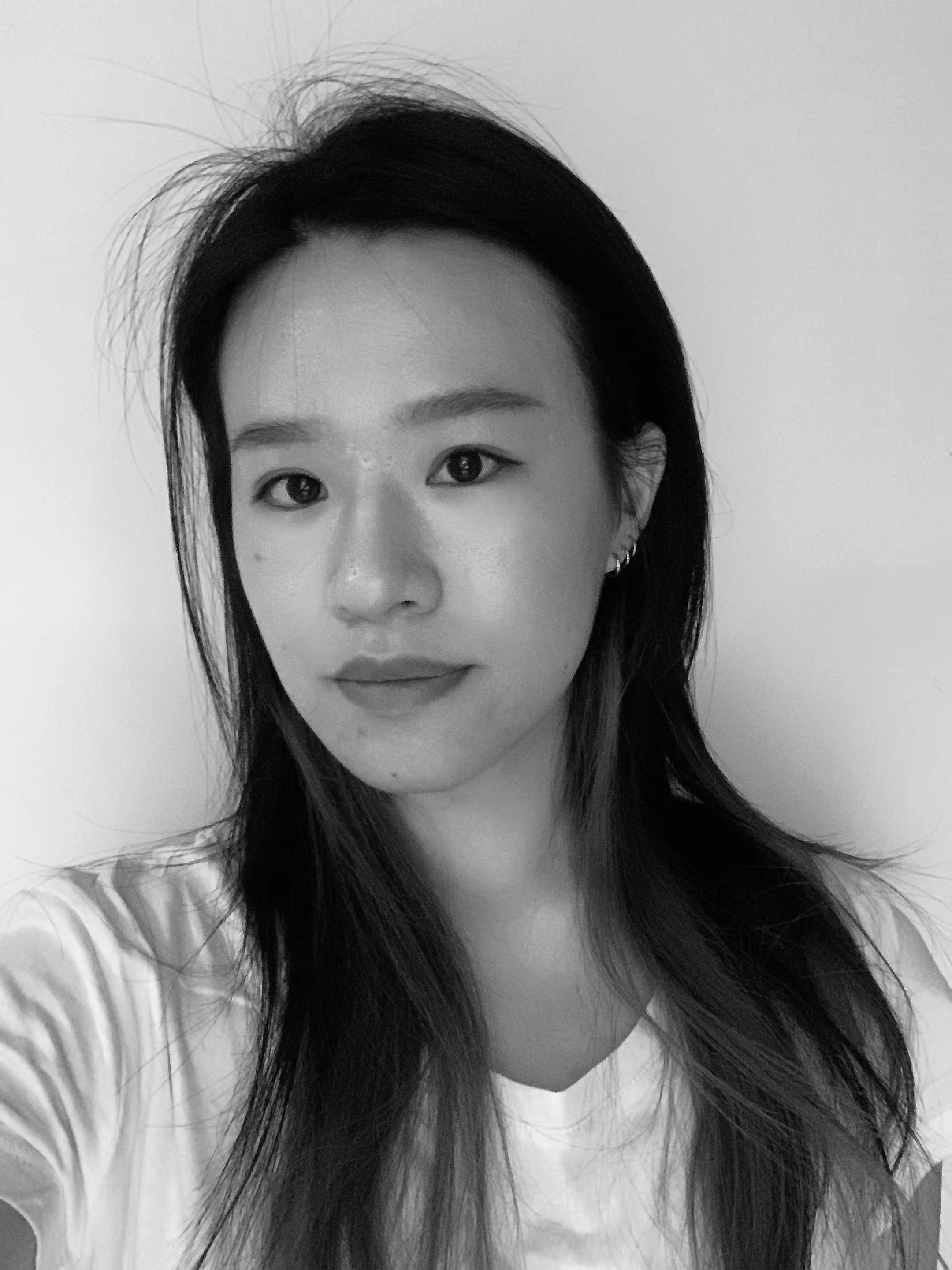A person faces the camera for a selfie. The image is in black and white.