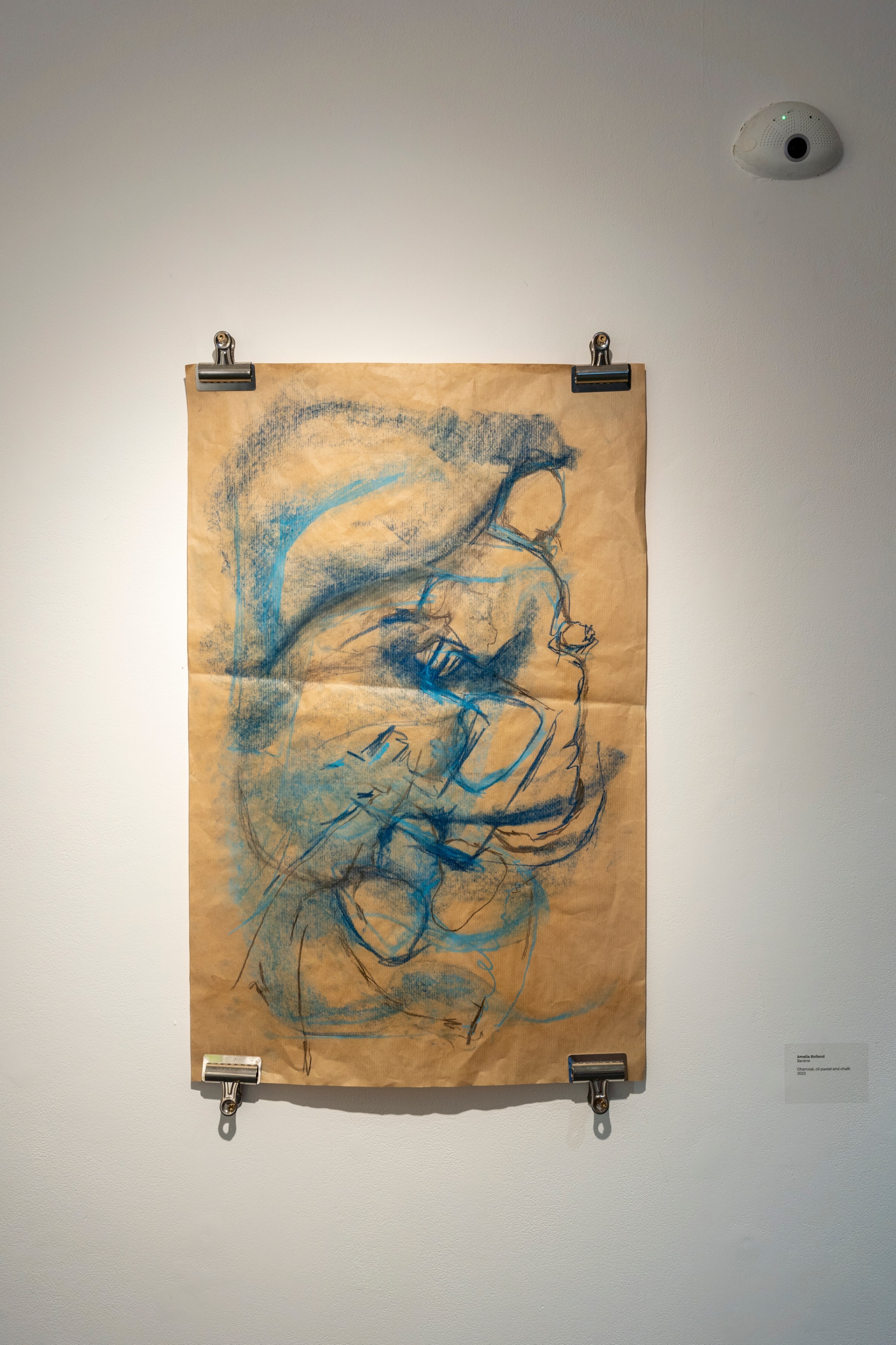 Large blue and black abstract mark making piece on brown paper