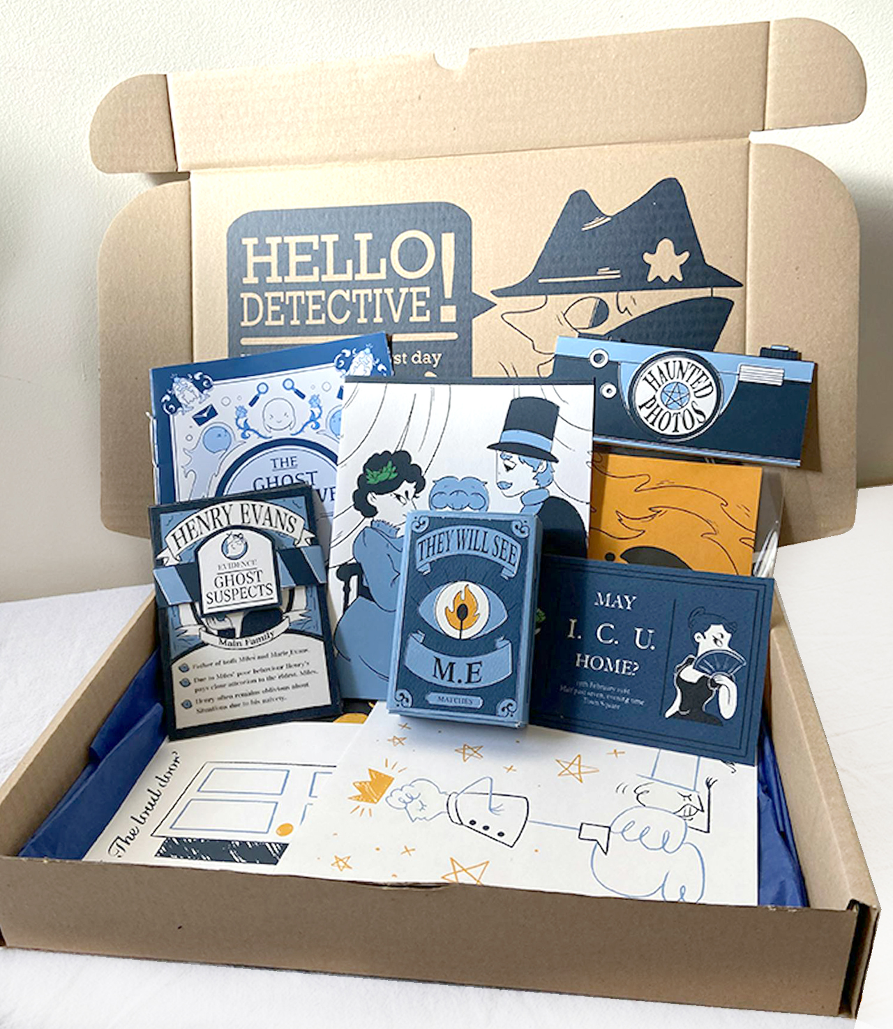 Box with parts of a detective card game, illustrated characters and blue/yellow theme.