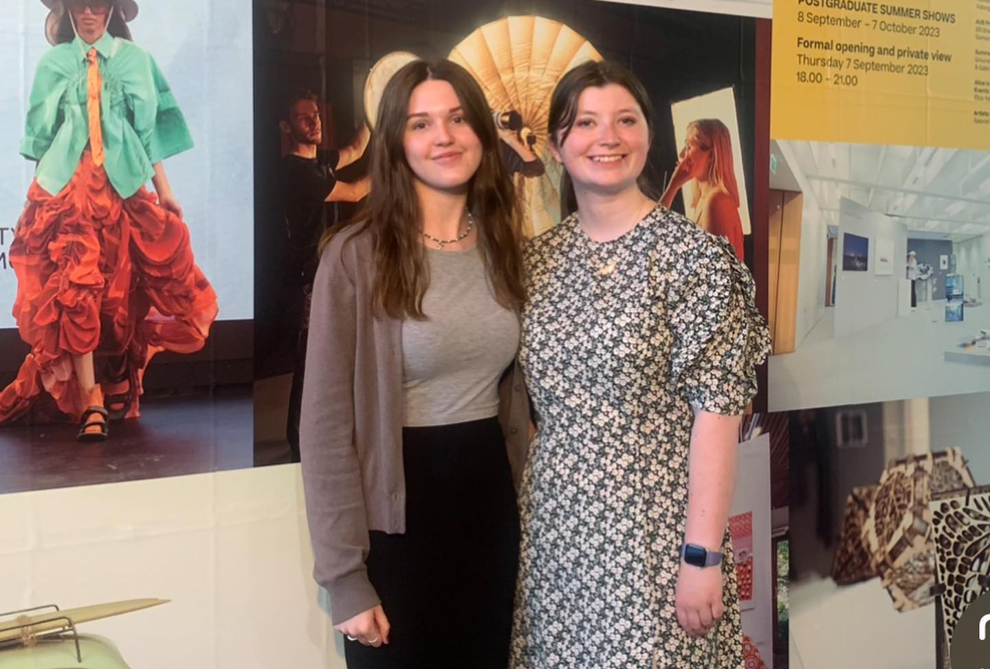 E Naden and M Harvey standing in front of a poster exhibit on AUB campus.