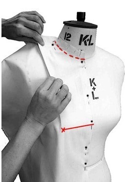 Fashion illustration: grey-scale figure beside white dress form with red measurement lines and black markings, hands positioned near garment.