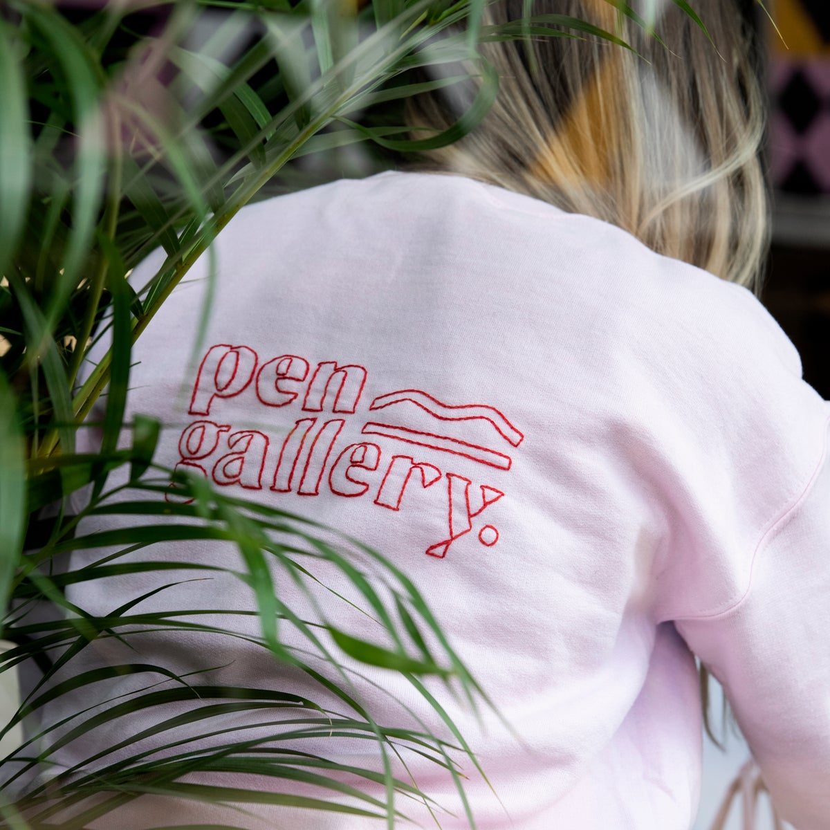 Back of jumper with the pen gallery logo