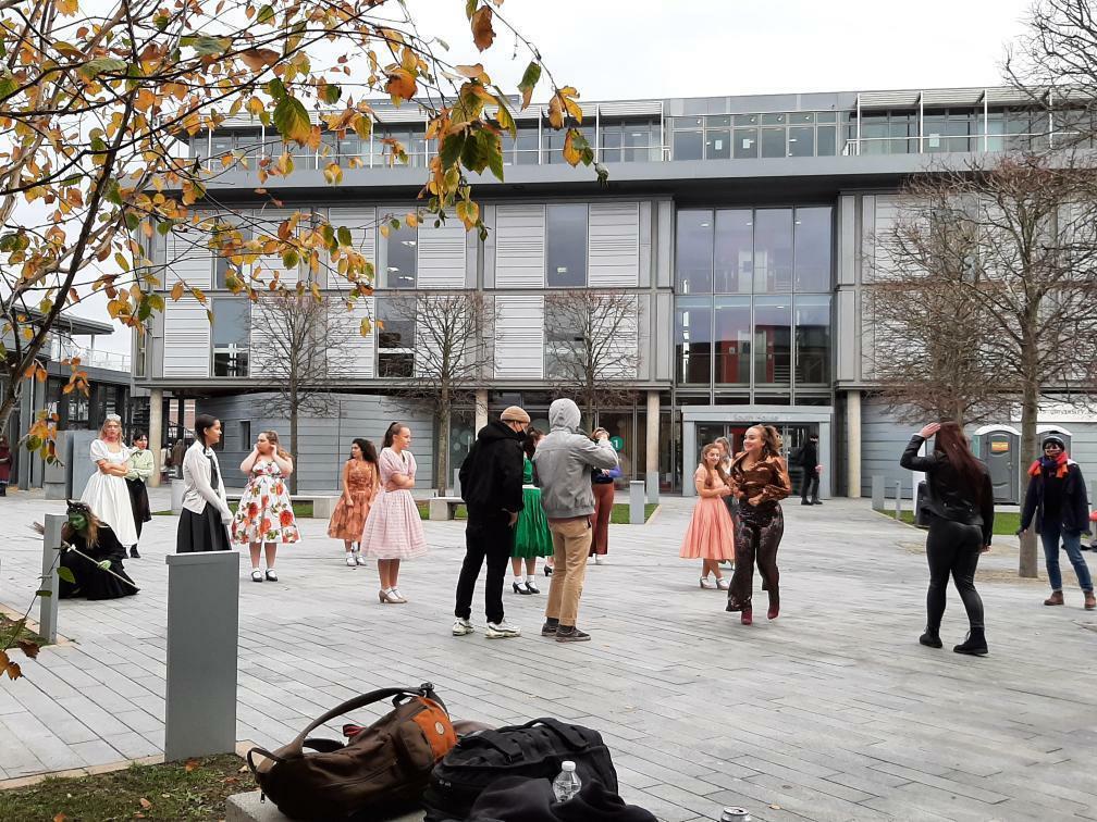Group of BA (Hons) Dance students on the main courtyard on AUB campus filming a routine.
