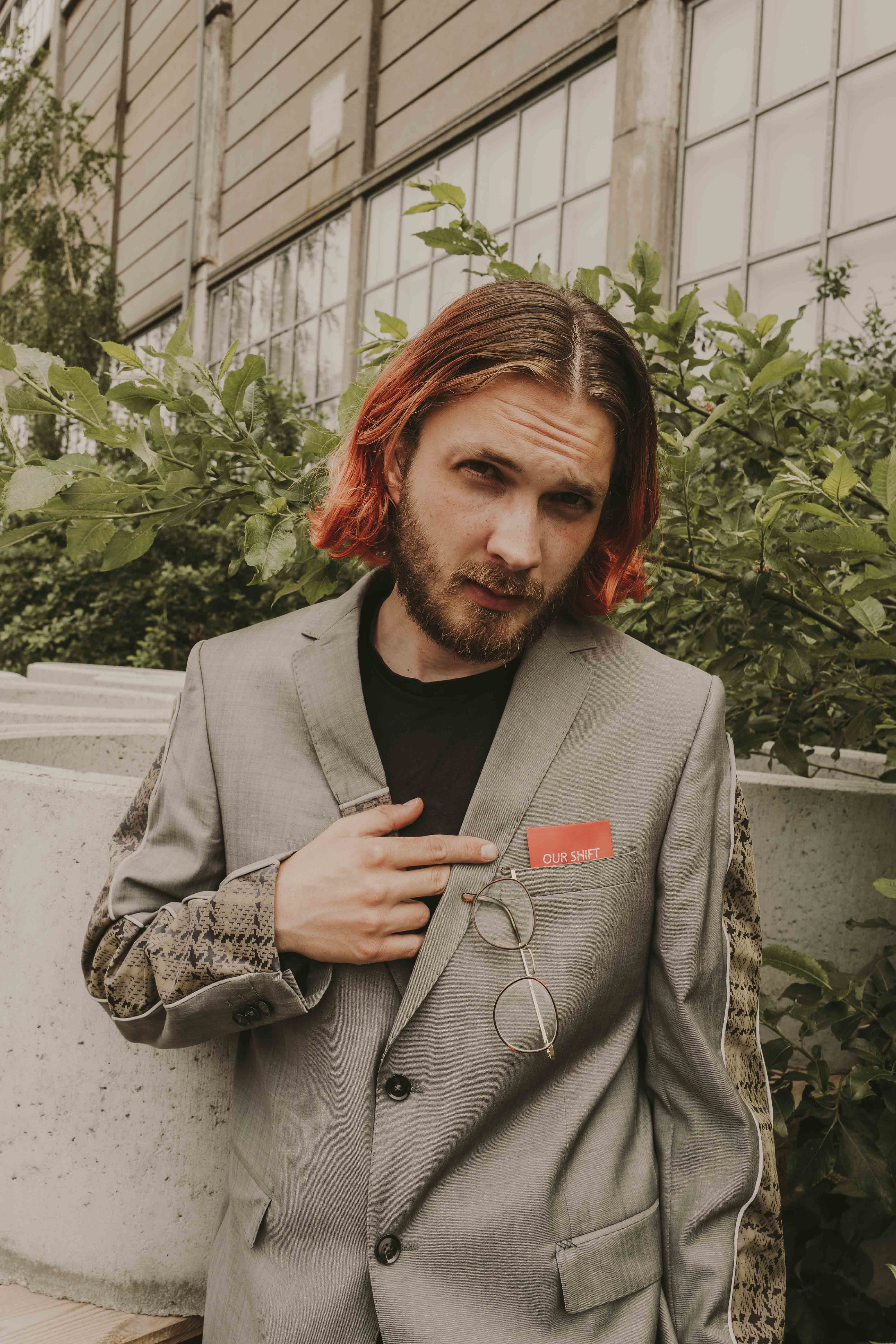 Graduate Milan Flicek wears an upcycled fashion garment created by OUR SHIFT