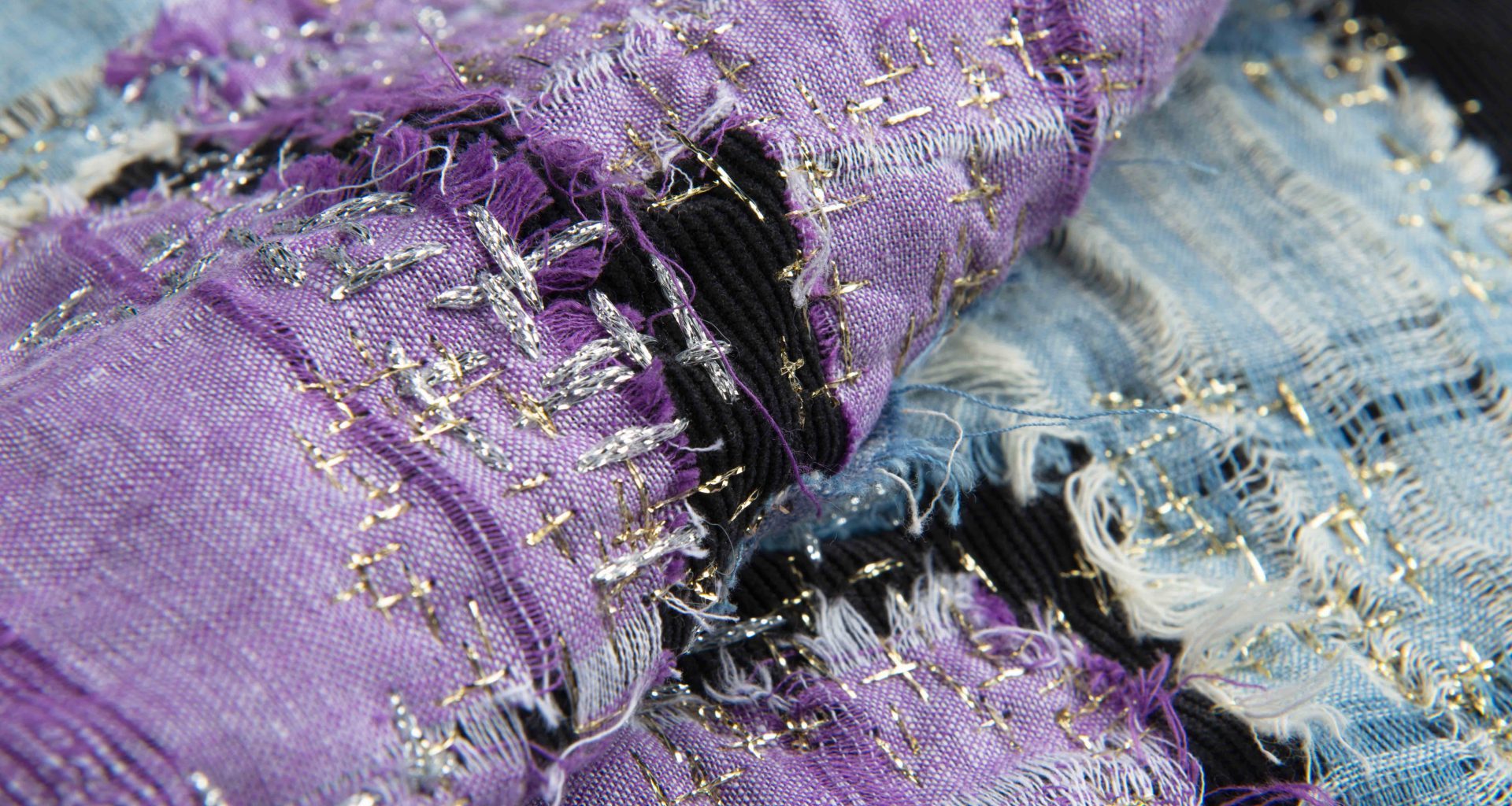 Closer image of two rolls of distressed fabric.