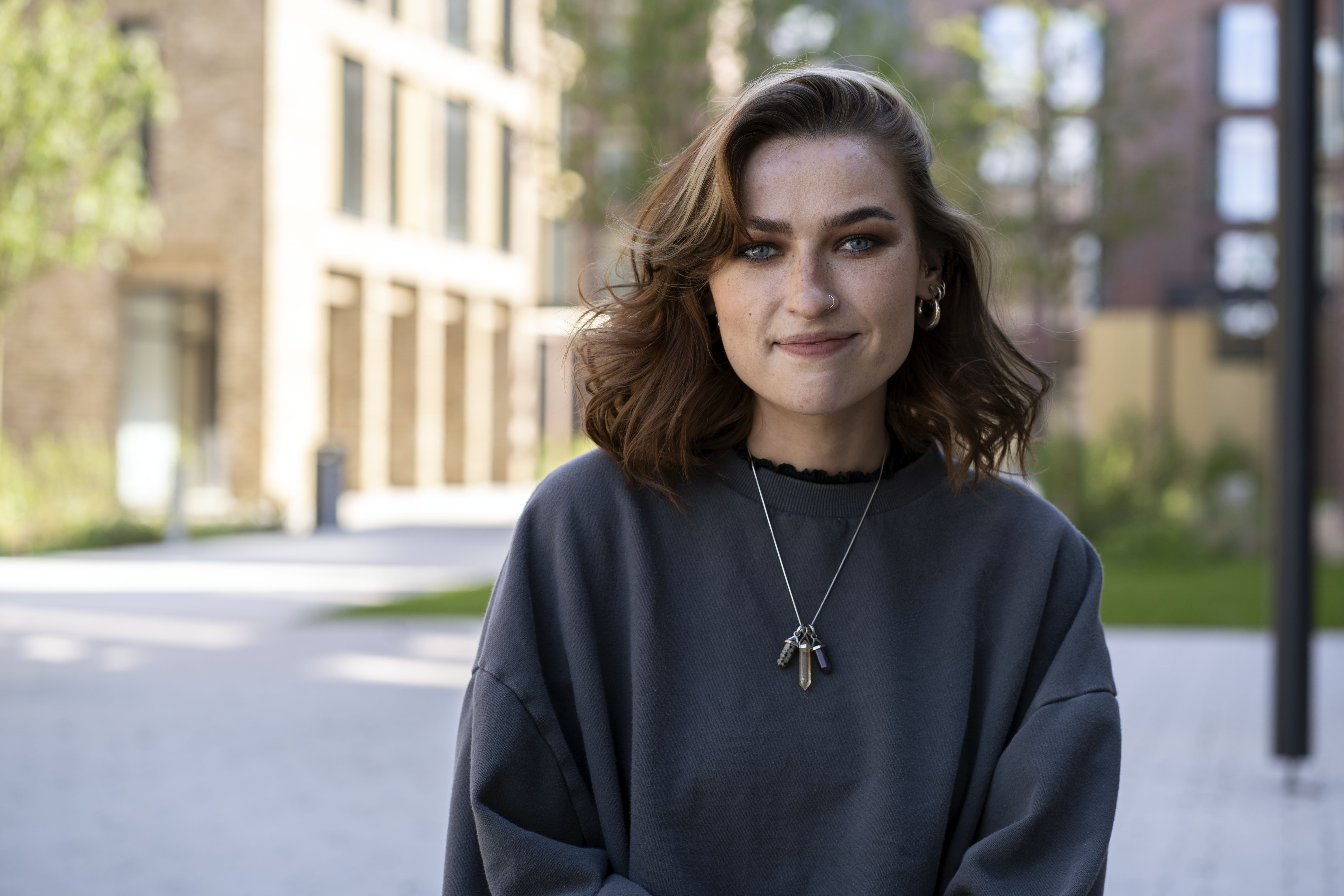 Headshot of S Baverstock with university campus buildings in the background.