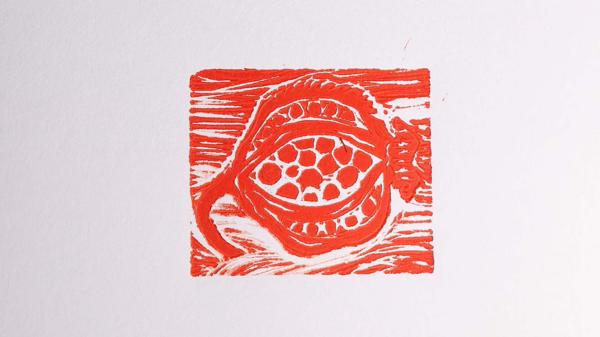 Red block print on white paper showing circular form with dotted centre surrounded by curved lines and horizontal striping.