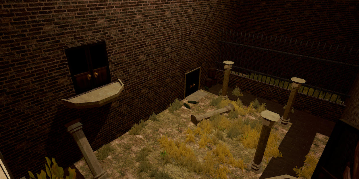 An abandoned indoor space with brick walls and a broken window. The floor is partly covered with overgrown grass, and there are scattered remnants like fallen columns and a door. A section of tall metal fencing is visible in the background.