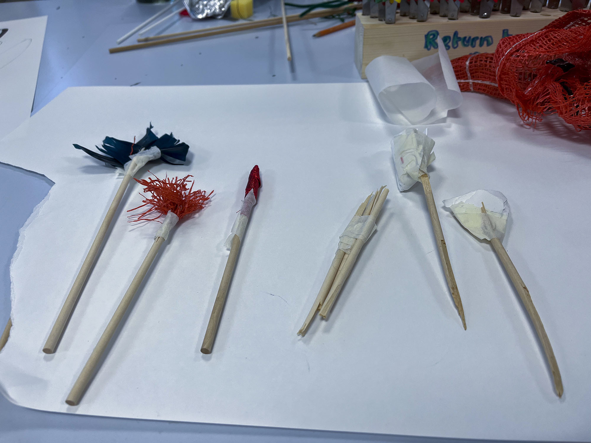 A series of paint brushes laid out on a table