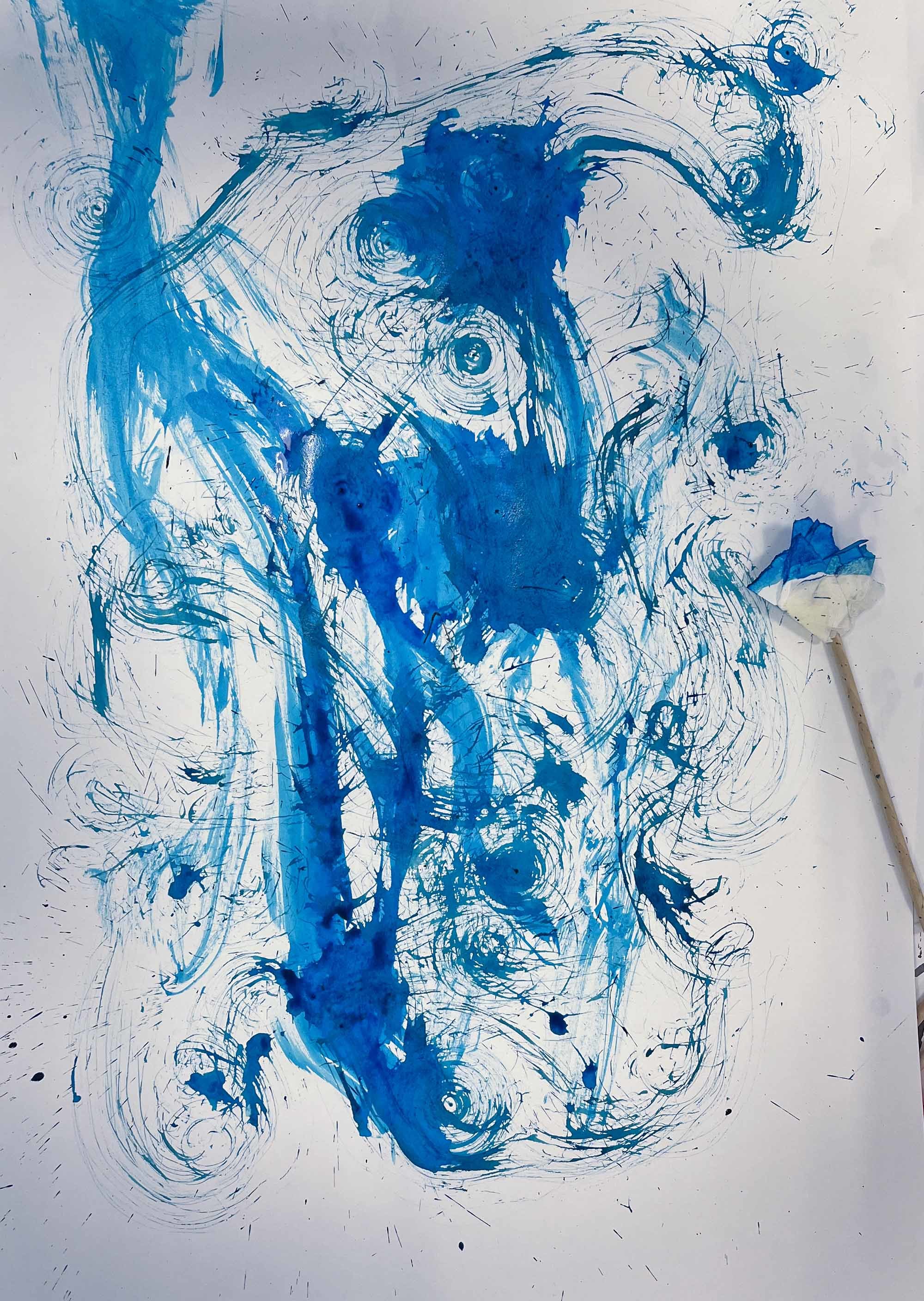 Flowing blue paint shapes painted across a canvas