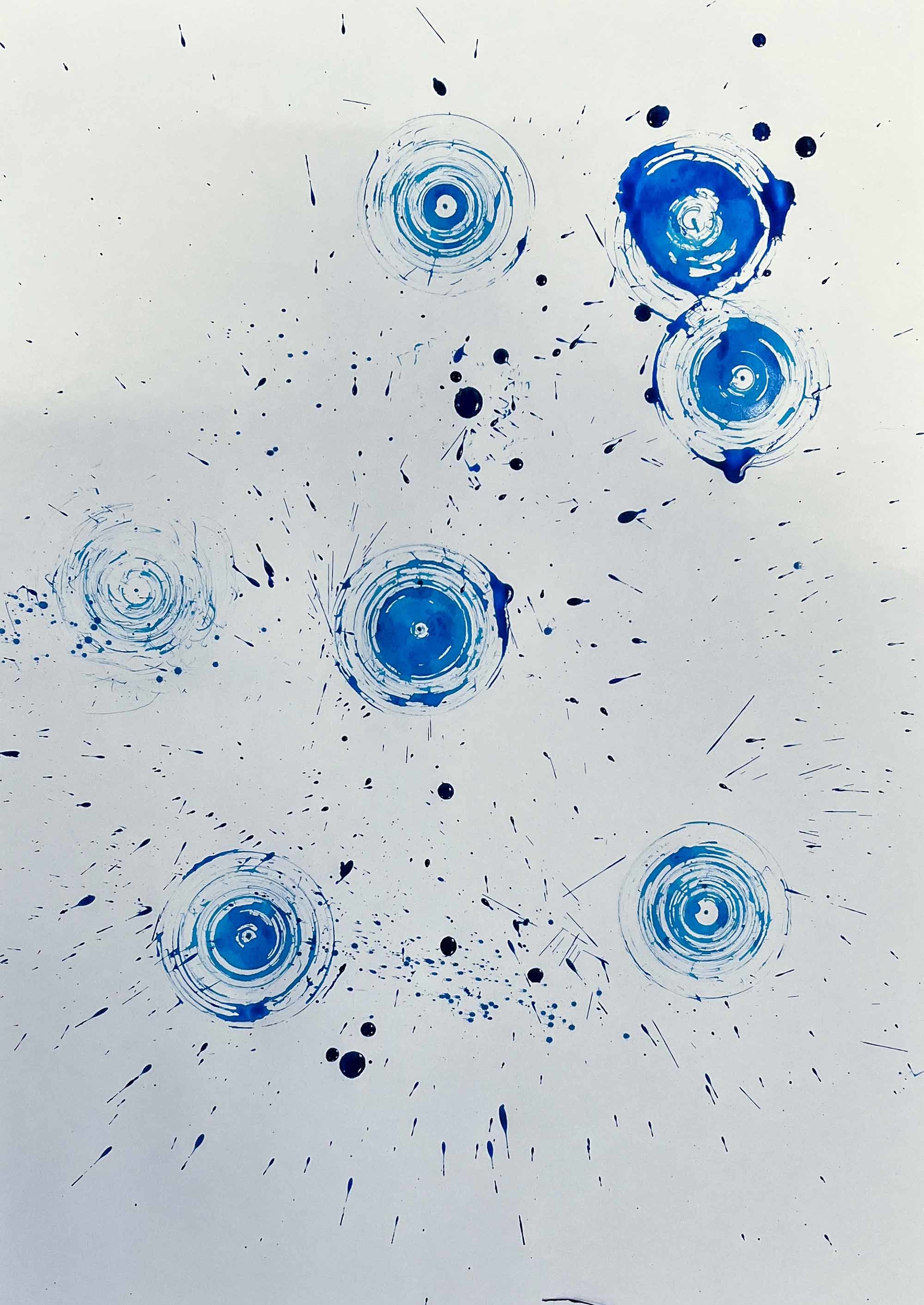 Blue painted circles on a canvas