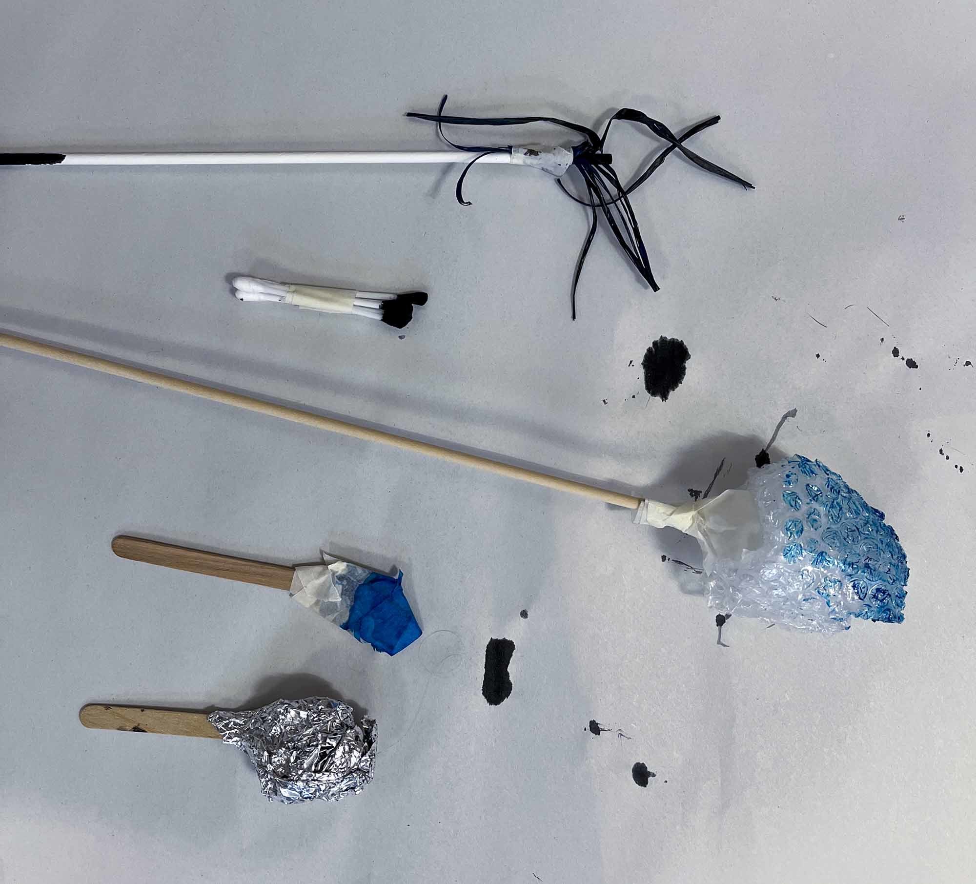 Painting implements lying on a blank canvas