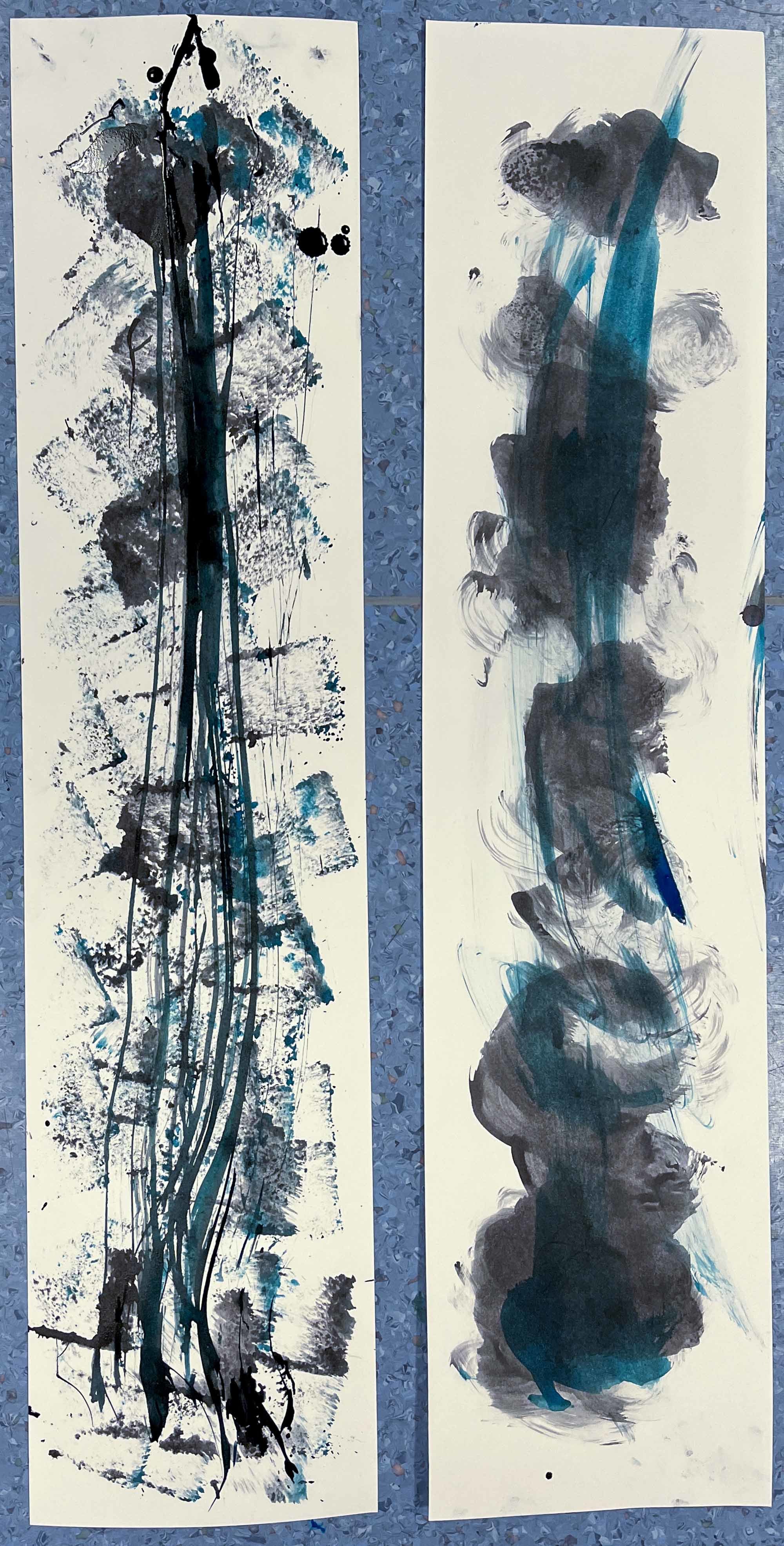 Two long strips of canvas with Multiple colours, mainly blue, green and blue paint