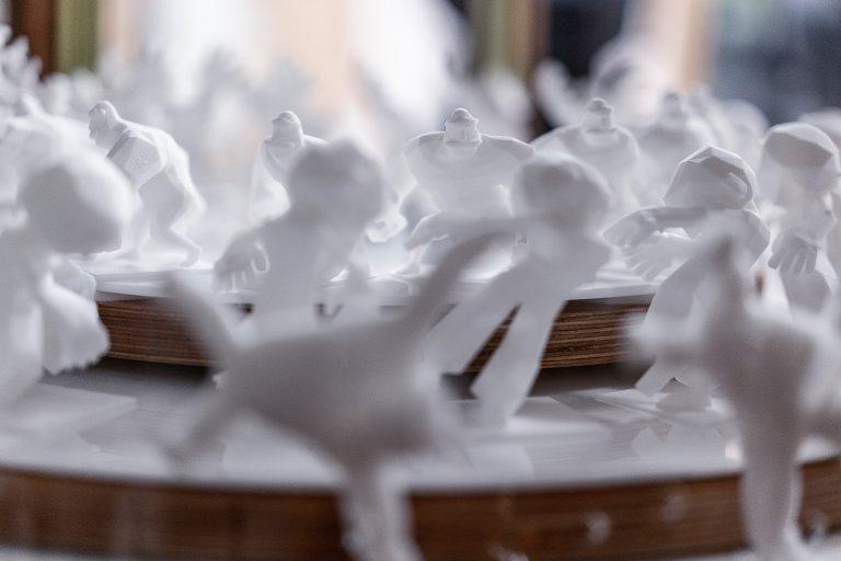 Three series of 3D figures arranged on platforms.