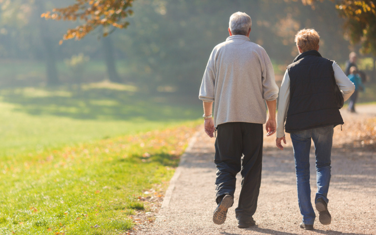An older couple walking along a path