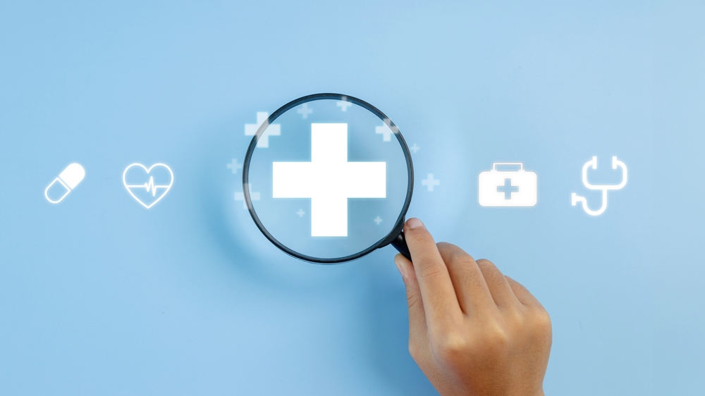 Magnifying glass with plus and medical icons for medical and health care concept
