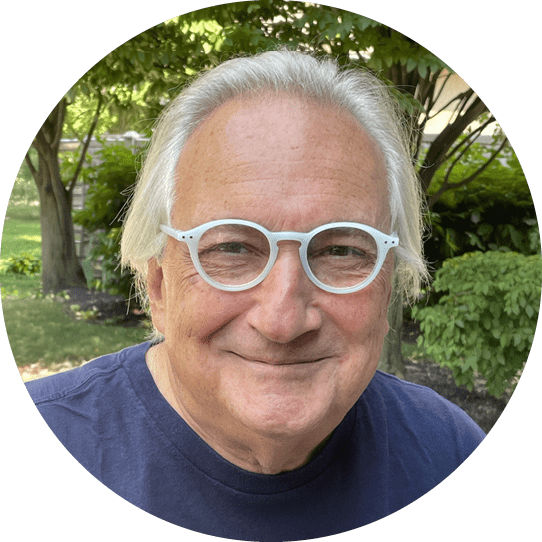 A man wearing glasses and a blue shirt. Description generated by AI