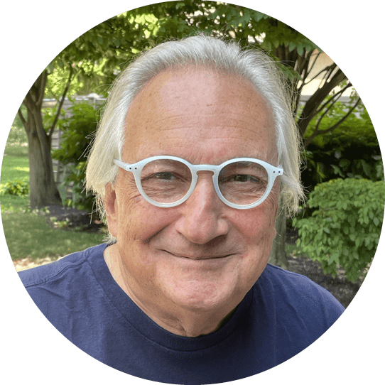A man wearing glasses and a blue shirt. Description generated by AI