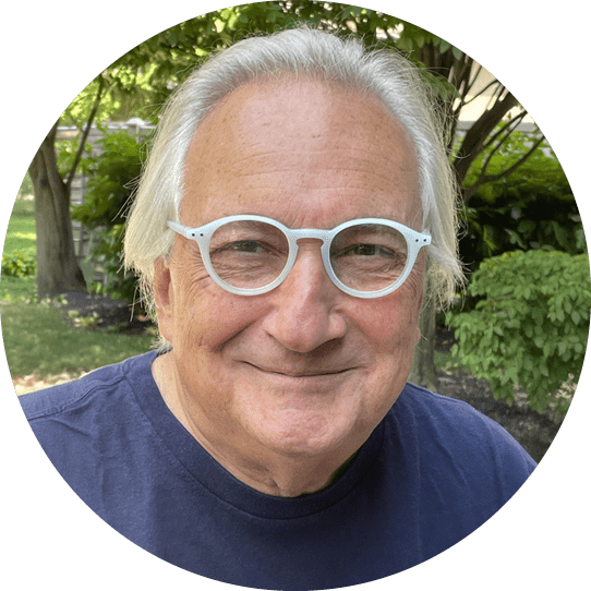 A man wearing glasses and a blue shirt. Description generated by AI