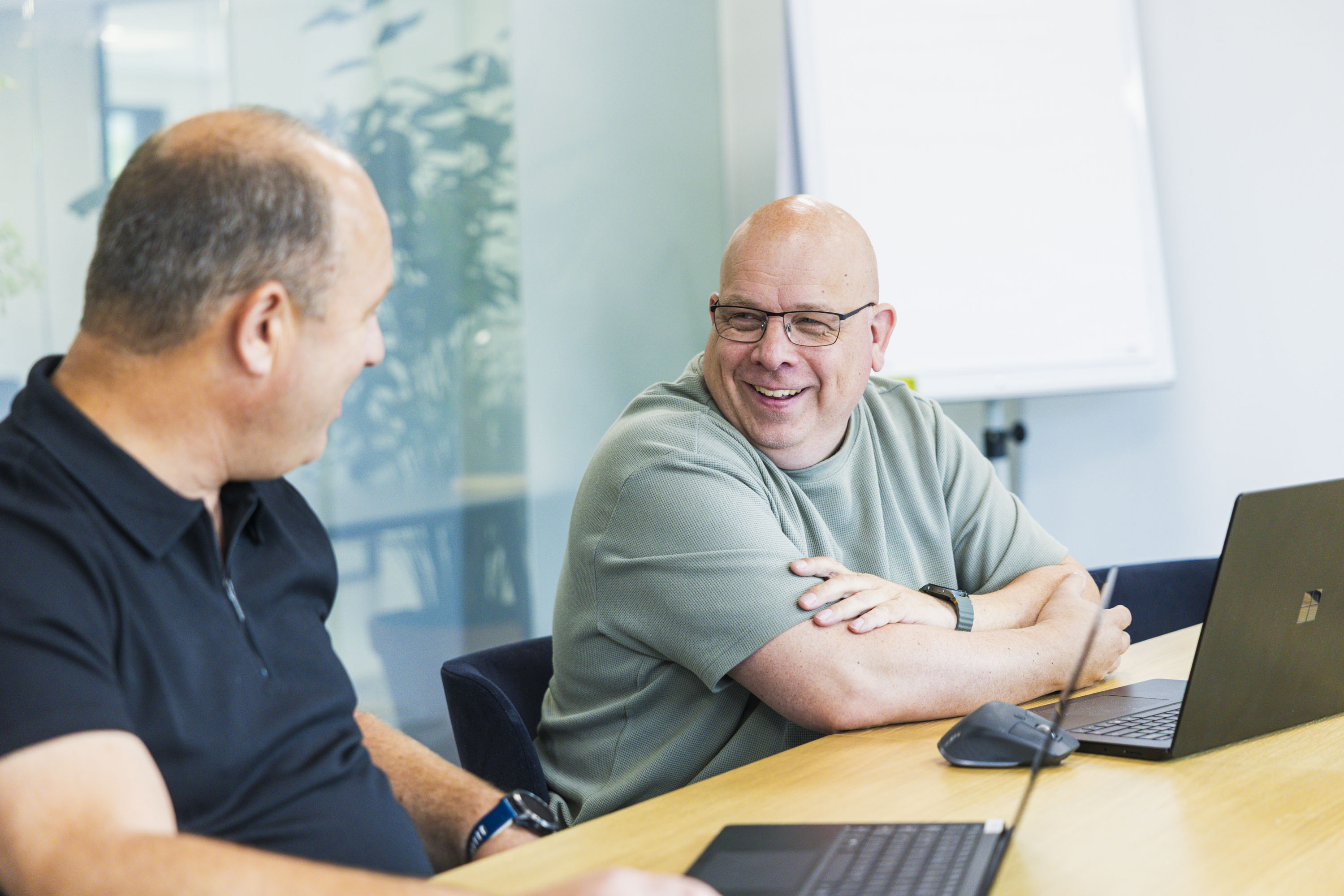Two colleagues talking in a meeting room