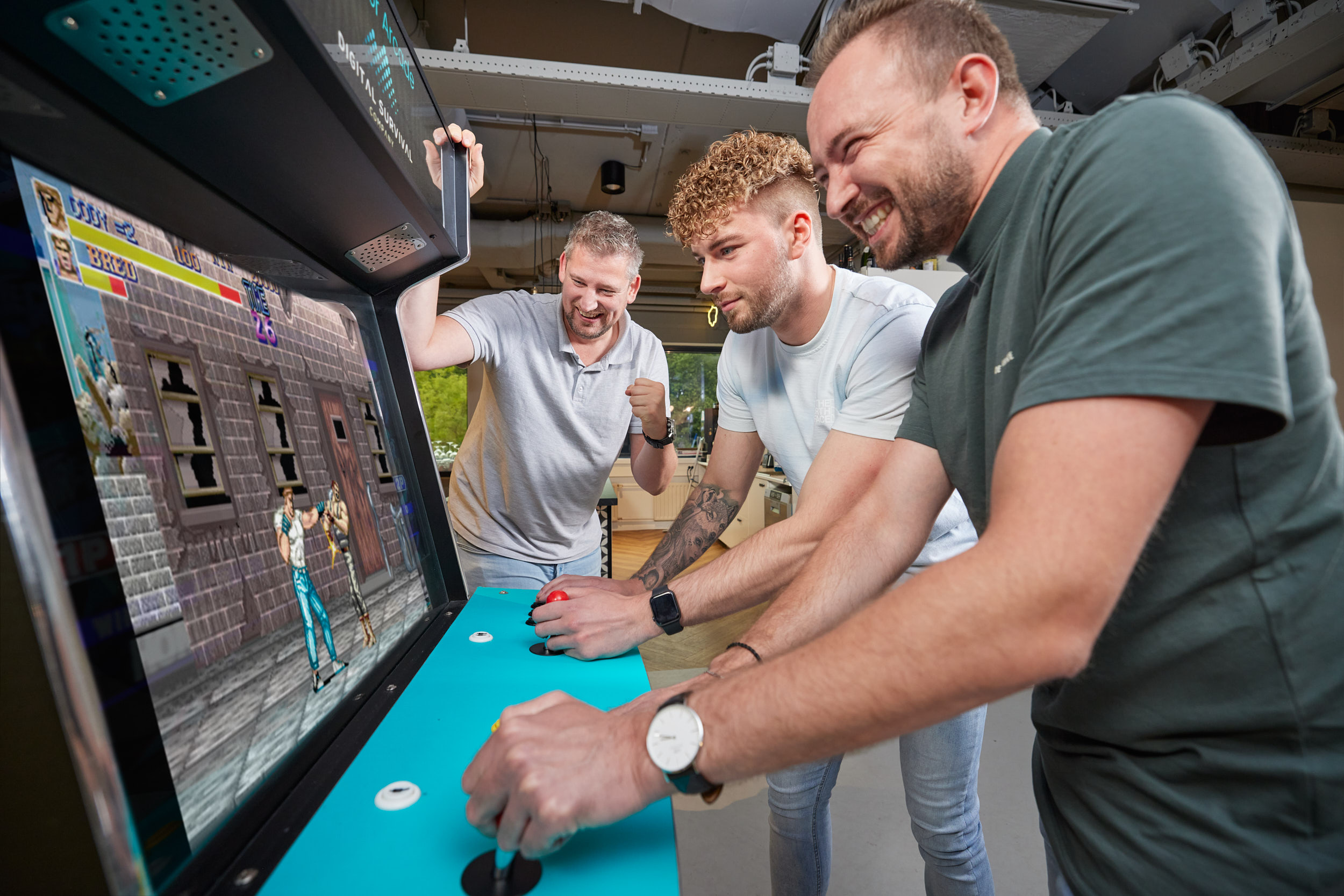 Colleagues playing an arcade game together