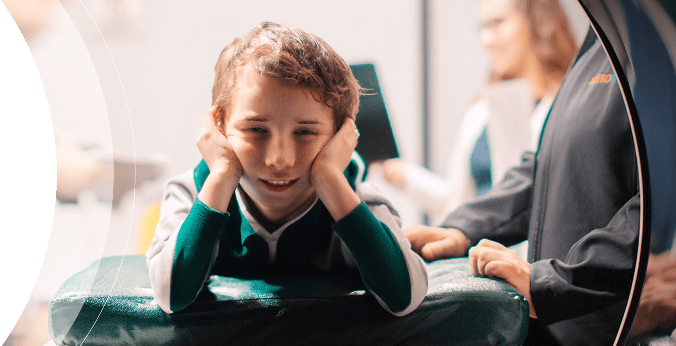 Boy smiling and laying down in NeuroCytotron with his head in his hands smiling
