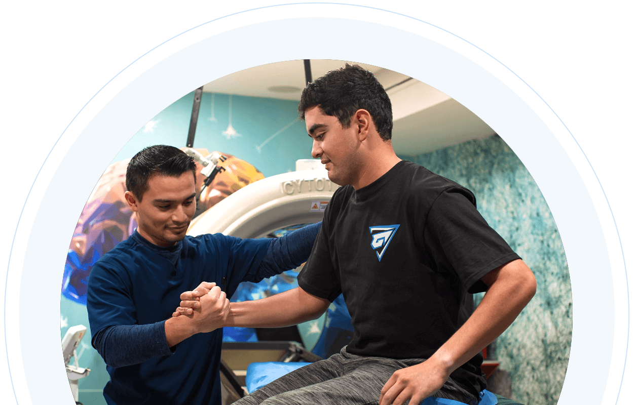 Technician working with adult male with cerebral palsy