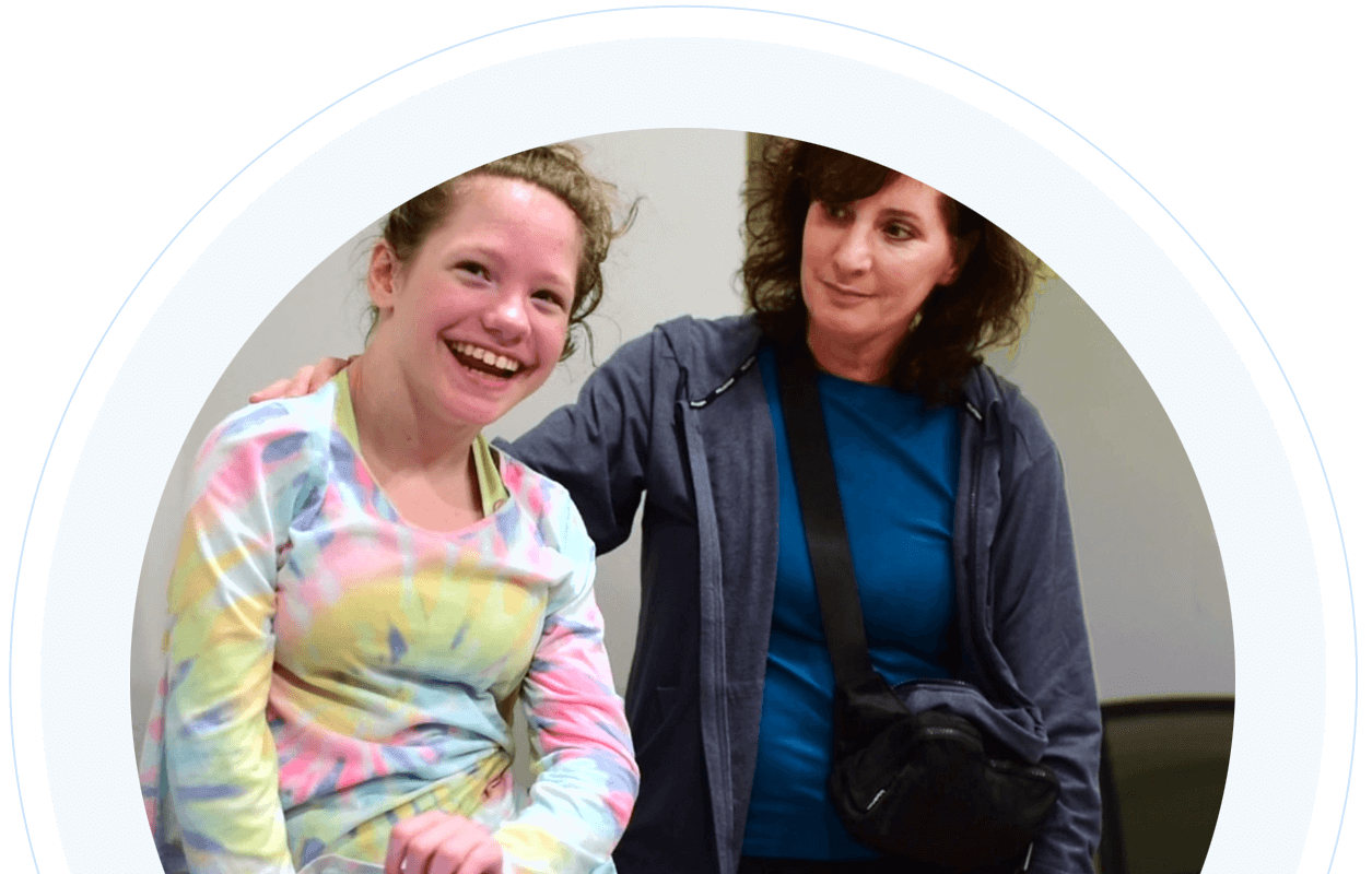 Young girl with cerebral palsy smiling with her mother