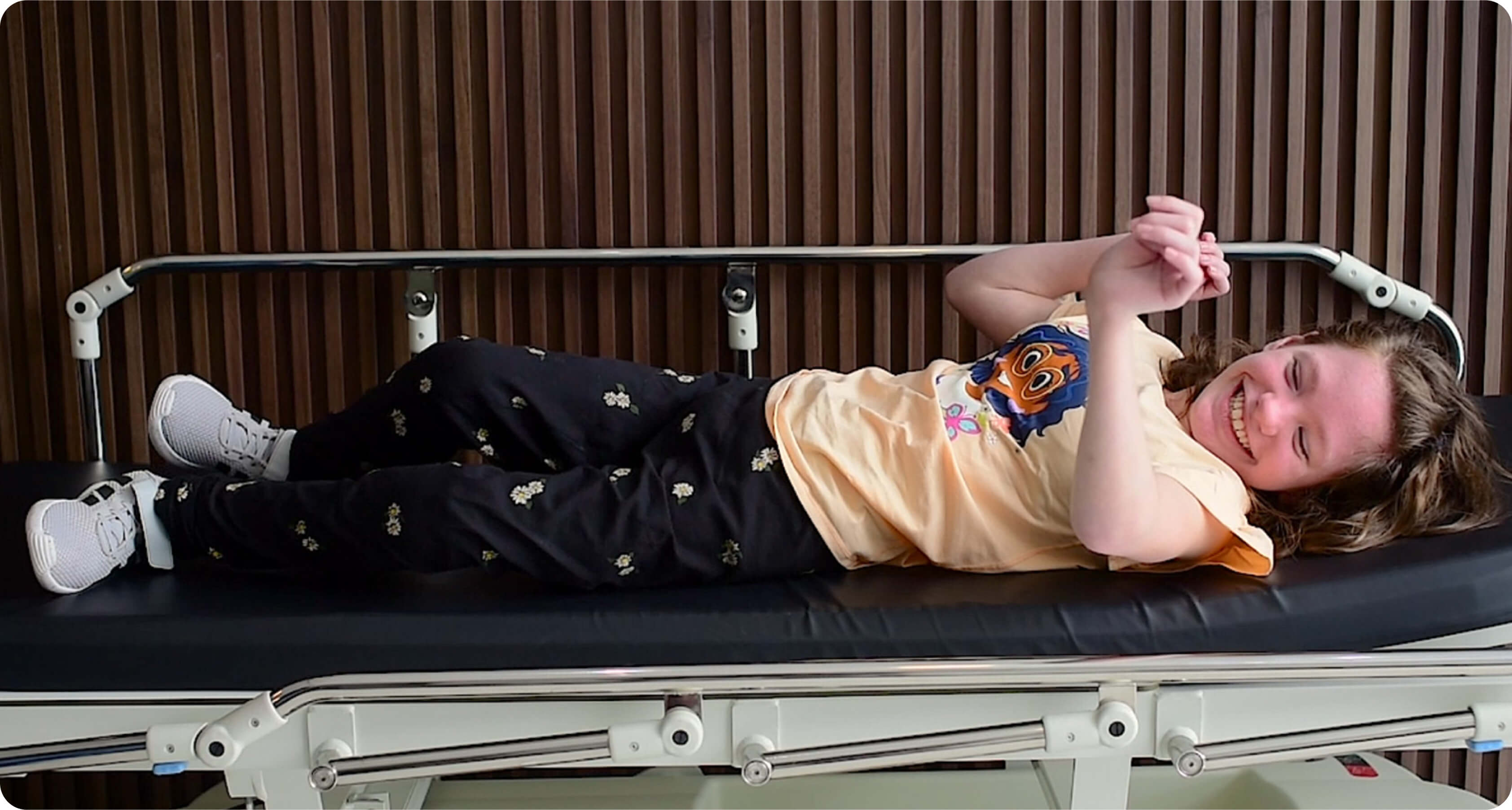 Teenage girl with cerebral palsy laying down on stretcher