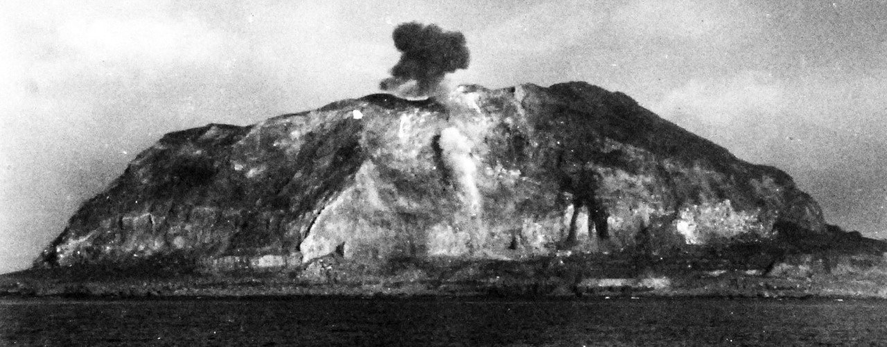 Planes strafing Iwo Jima, with Mt. Suribachi smoking from the bombs. U.S. Official Navy photograph, now in the collections of the National Archives.