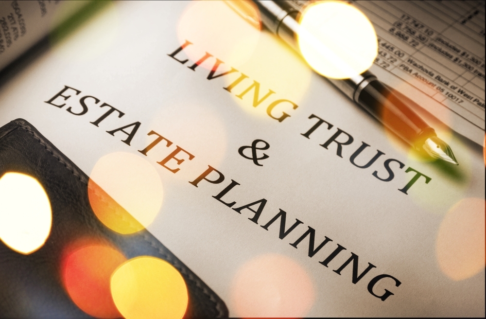 Paperwork on desk titled 'Living Trust and Estate Planning' beside a pen.