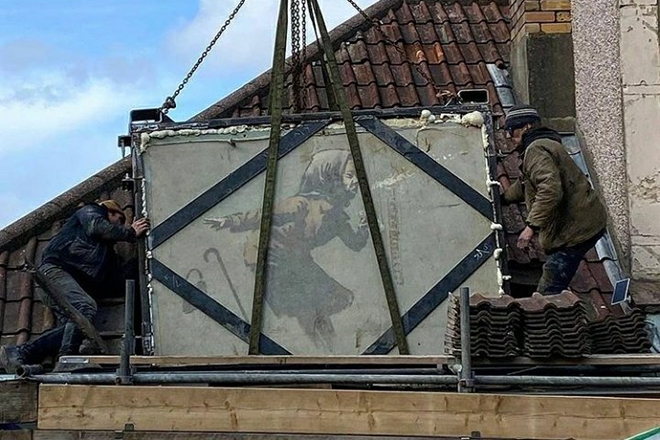 Banksy's sneezing woman mural has been removed from the wall of a house in Bristol