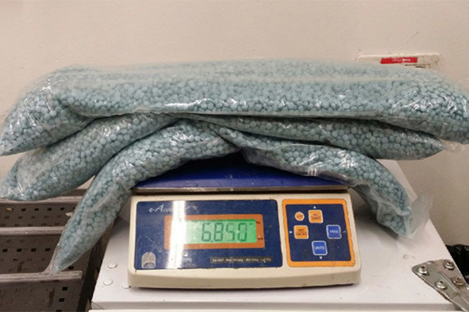 A mother and son were caught with 100,000 ecstasy pills in their luggage