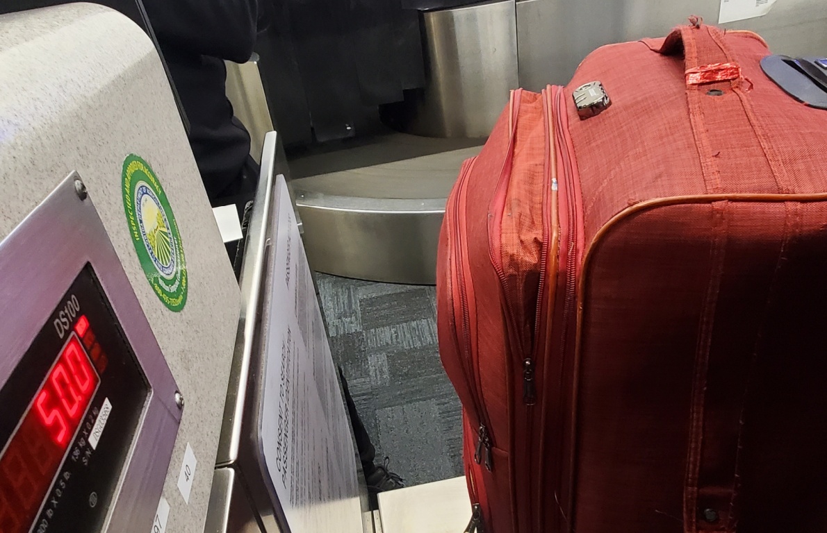 Checked luggage being weighed at an airport