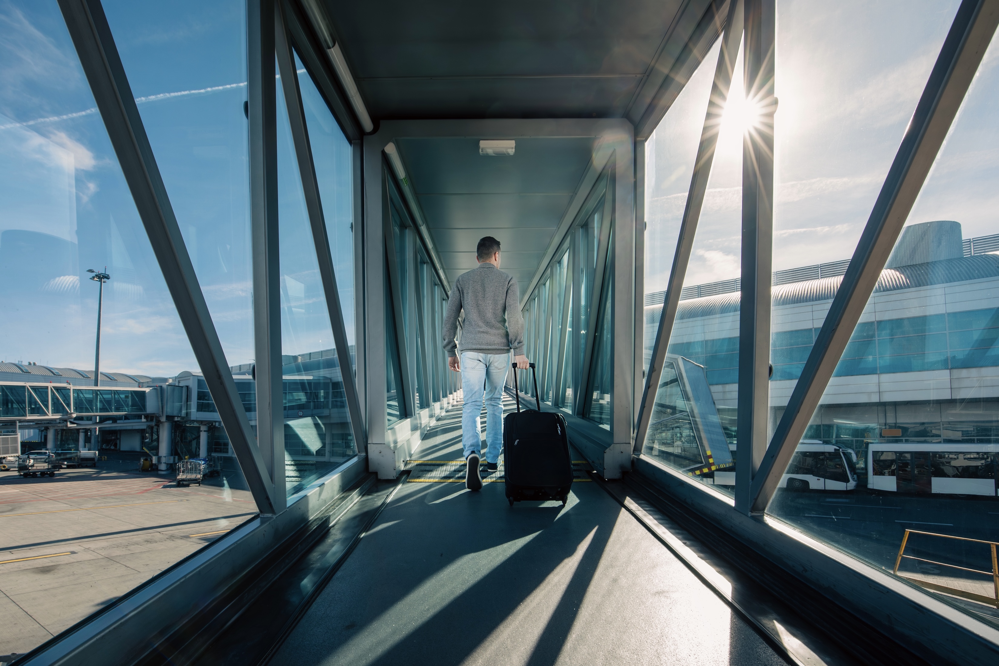 solo passenger walks on airport jetway